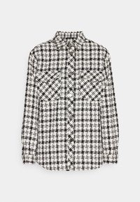 Sort og hvid ternet skjorte med knapfront, to brystlommer, krave og lange ærmer. Teksturområde med et ternet mønster.