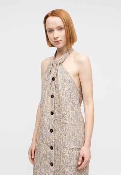 Πλεκτό φόρεμα με λαιμόκοψη halter και υφή σε μπεζ και μπλε, με δέσιμο στον λαιμό και σκούρα κουμπιά μπροστά.