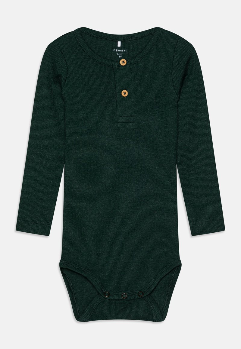 Bodysuit à manches longues en velours côtelé vert forêt, avec un col rond, deux boutons en bois à l'avant et des fermetures à pression en bas.