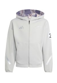 Veste à capuche grise clair avec fermeture éclair à l'avant, dotée d'une doublure intérieure à motifs, d'accents réfléchissants et de poches latérales. Comprend des détails de logo.