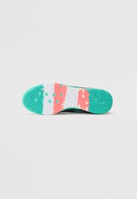 Sneaker sole with multi-colored pattern; turquoise, white, and coral sections; textured for traction; hexagonal and geometric designs visible.