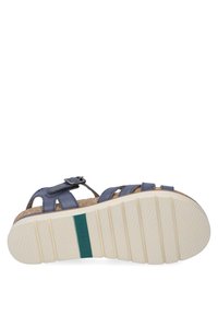 Blue leather sandal with cork insole, adjustable strap, and a textured white rubber outsole. Green accent on the sole with ridged pattern.