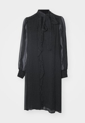 Schwarzes Kleid mit weißen Punkten, langen durchsichtigen Ärmeln, einem Bindekragen und einem gerafften Vorderteil. Leichter Stoff mit lockerer Passform.