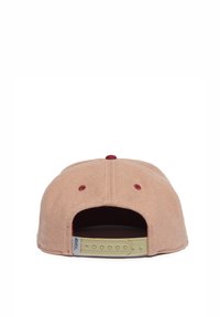 Pink fabric baseball cap with a suede texture, adjustable beige strap at the back, and maroon accents around ventilation holes.
