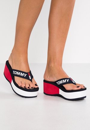 Czarne i granatowe sandały na platformie z białą i czerwoną podeszwą, z plecioną ramiączką z napisem "TOMMY". Teksturowana wkładka i wyraźne kolory.