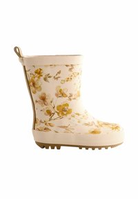 Botte de pluie crème avec un motif floral jaune et marron, semelle blanche texturée avec adhérence, et une languette à l'arrière pour un enfilage facile.
