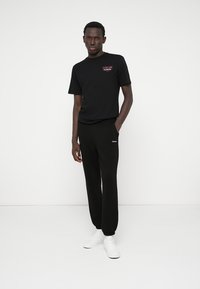 CLOSURE London VINTAGE STAMP TEE - Nyomott mintás póló - black