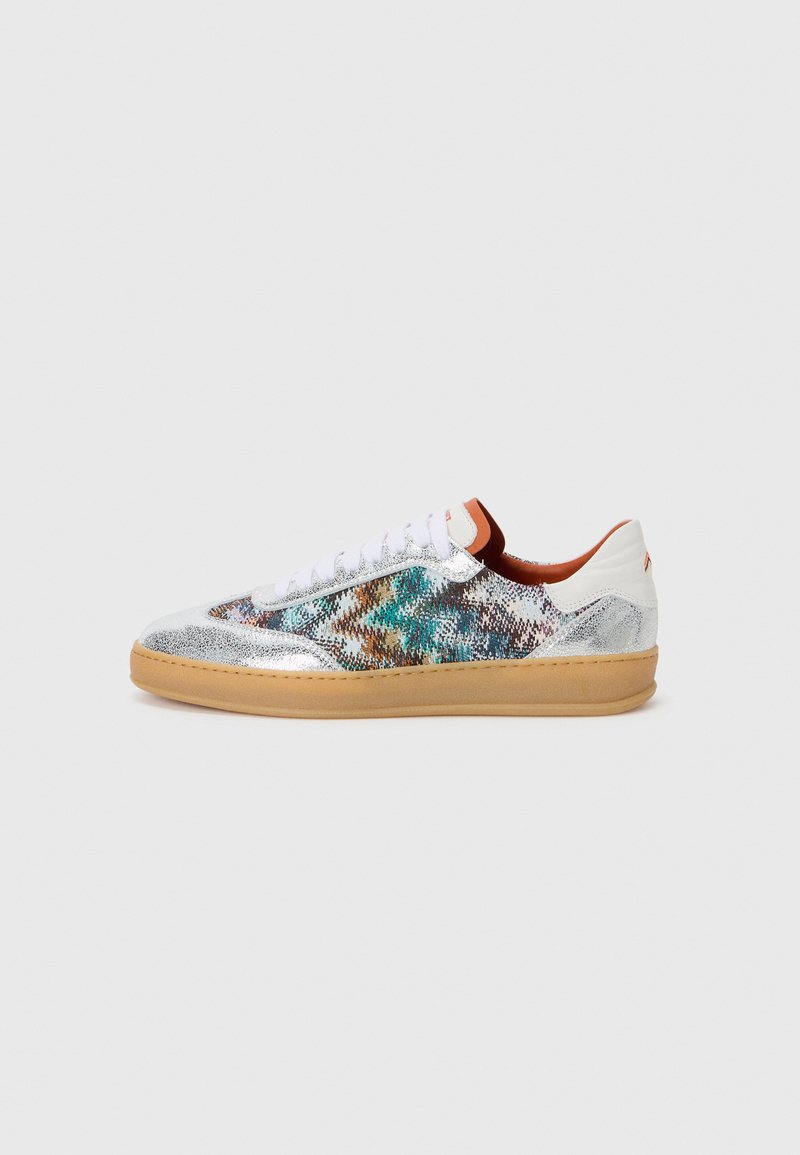 Sneakers featuring a metallic silver upper with colorful textured patterns, white laces, and a gum rubber sole. Accents include a brown heel tab.