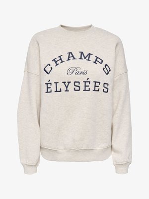 Beige crewneck sweatshirt with navy blue text "CHAMPS ÉLYSÉES" and "Paris" in smaller cursive font between the words.