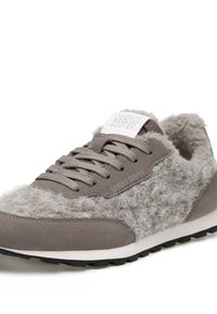Gray sneaker with fuzzy texture on the side, suede material, and lace-up design. Features a white logo on the tongue and a black outsole.