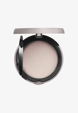 Compact powder in a round black case with a hinged lid. Smooth, light beige surface, minimal shine, and clean design.