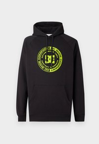 Black hoodie with front pocket and neon yellow circular logo reading "DC Shoe Company, Destroy & Create, Established 1994" on chest.