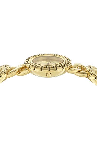 Auksuotas laikrodis su apvaliu korpusu, tekstūruotu bezeliu ir susijungiančia apyranke. Stiklinis ciferblato skydelis su sidabrinėmis rodyklėmis ir spinduline dialo rašto tekstūra.