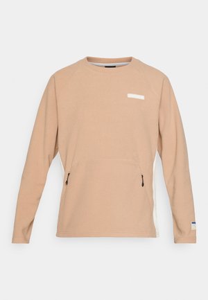 Beige sweatshirt met lange mouwen en een gestreept patroon, zijkant ritszakken en een witte accentstreep. Beschikt over een logo op de borst.