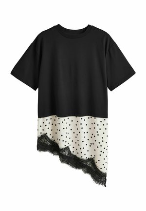 Black short-sleeve top with an asymmetrical white polka dot hem and black lace trim at the bottom.
