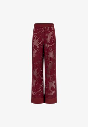 Burgundy wide-leg pants with a sheer floral lace overlay. Features a solid waistband and hem detailing, showcasing intricate flower patterns.