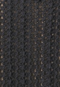 Dark navy textured fabric with an open-knit pattern, featuring intricate loops and a slightly transparent quality.