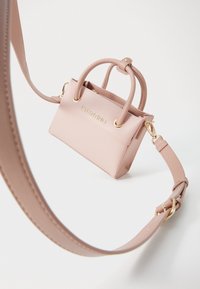 Small pink leather handbag with structured design, featuring dual top handles, a detachable strap, and gold hardware accents.