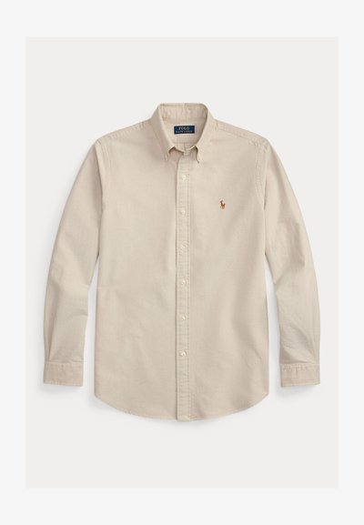 Beige overhemd met lange mouwen, knoopsluiting en kraag, geborduurd Polo Ralph Lauren-logo op de borst, en knoopmanchetten.