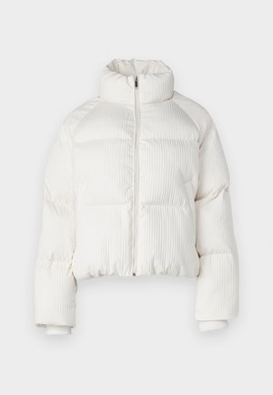 White cropped puffer jacket with vertical ribbed texture, high collar, front zip closure, and elastic cuffs. Features side pockets.