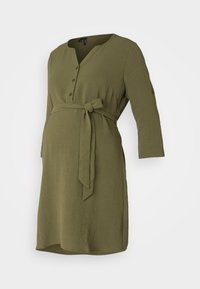 Olive green maternity dress, polven pituus, pitkät hihat, napitettu etuosa, vyötärölle sidottu, valmistettu pehmeästä tekstuurista.