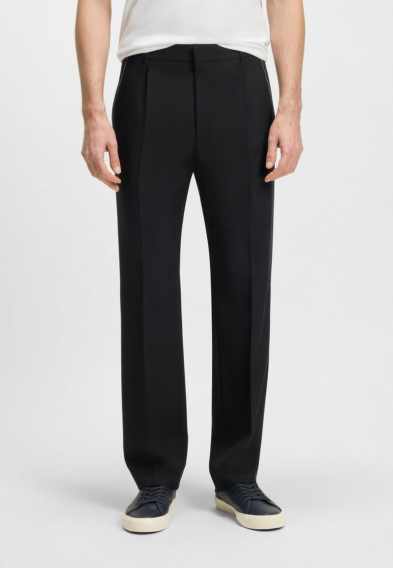 Black tailored trousers featuring a flat front, side pockets, and a straight-leg design. Made of smooth fabric with a slight sheen.