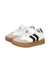Zapatillas blancas y beige con rayas negras, que cuentan con una correa de velcro y cordones, suela de goma y detalles texturizados en la parte superior.