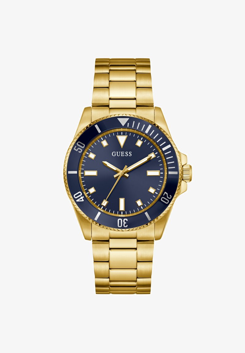 Relógio em aço inoxidável com acabamento dourado, mostrador azul marinho, marcadores de horas prateados e uma pulseira de elos combinante. Bezel rotativo e coroa gravada.