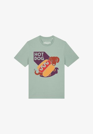 T-shirt vert clair avec un motif d'un chien teckel à l'intérieur d'un pain hot-dog et le texte "HOT DOG" au-dessus.