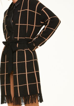 Black and beige checked cardigan with long sleeves and fringe hem; features a tied belted waist and soft texture.