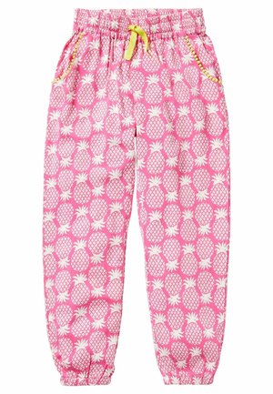 Pantalon rose à taille élastique avec imprimé ananas blanc, cordon jaune, poches latérales bordées de jaune et poignets élastiques aux chevilles.