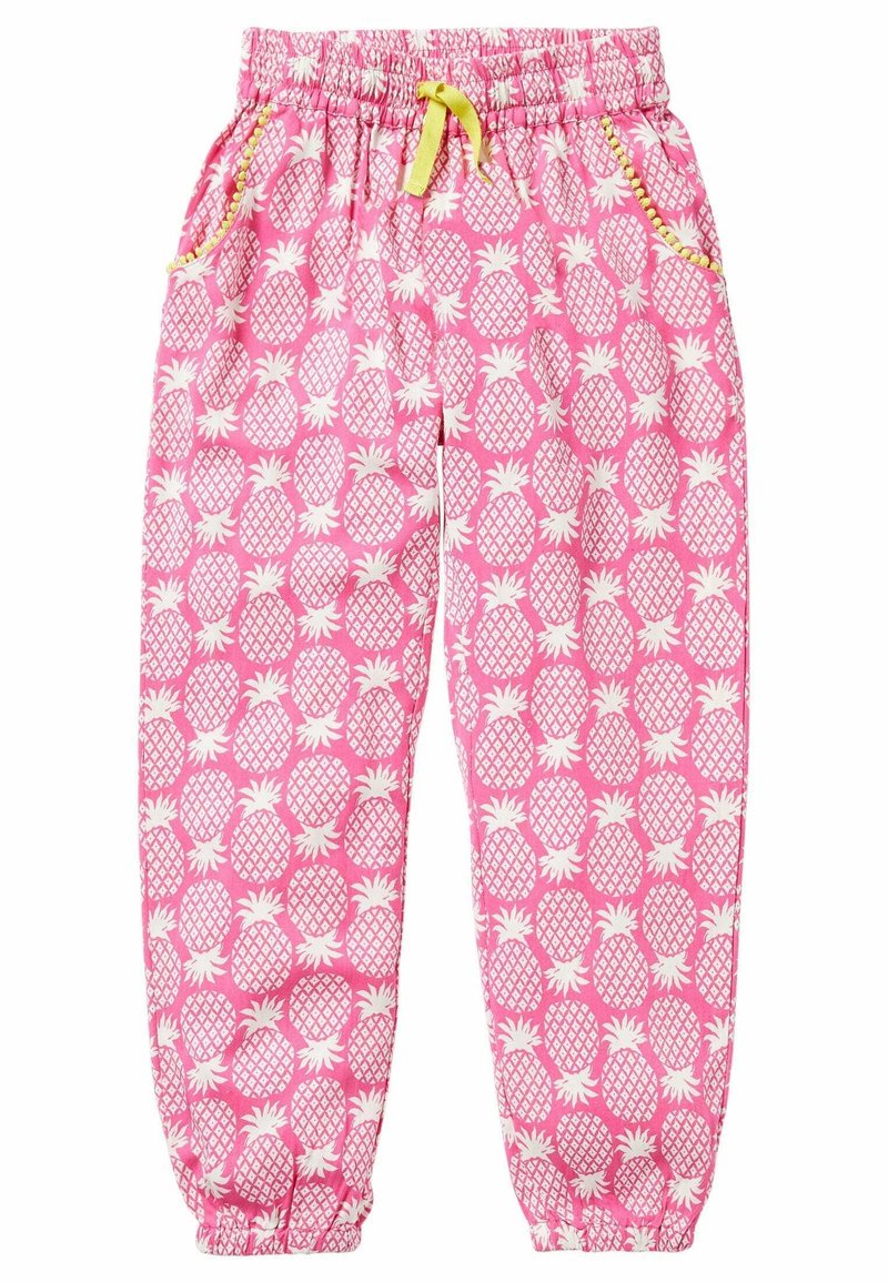 Pantalon rose à taille élastique avec imprimé ananas blanc, cordon jaune, poches latérales bordées de jaune et poignets élastiques aux chevilles.
