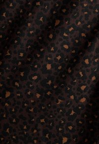 Brown fabric featuring a leopard print pattern, with dark black spots and lighter brown accents, showcasing a textured, woven appearance.