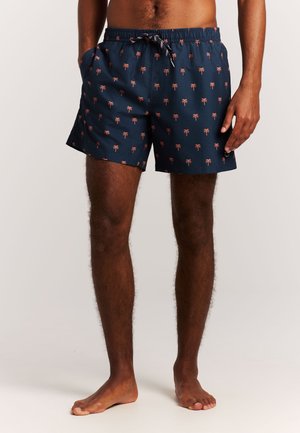 Marineblauwe zwemshorts met een patroon van roze palmbomen. Gemaakt van lichtgewicht stof, voorzien van een elastische tailleband en zijzakken.
