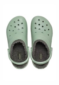 Mint green Crocs with ventilation holes, soft gray fleece lining, and adjustable heel strap for a secure fit.