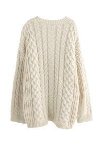 Kræmfarvet strikket sweater med et kabelmønster, brede ærmer og en afslappet pasform. Struktureret strik med ribbede manchetter og forneden.