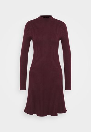 Burgundy ribbed knit dress with long sleeves, high neckline, and flared hem. Smooth texture, form-fitting silhouette.