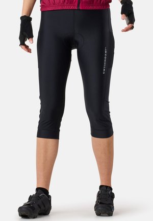 Black cycling tights with a fitted design, knee-length cut, and padded seat. Features a logo on the side and is made of flexible material.