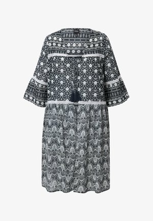 Kleid in Marineblau und Weiß mit kurzen, ausgestellten Ärmeln. Verfügt über eine Spitzenborte und Quastenakzente am Ausschnitt. Leichtes, fließendes Material.