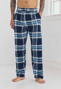 Pantalons de pyjama en tissu léger à carreaux bleu marine et bleus, avec une taille élastique munie d'un cordon de serrage et des poches latérales.