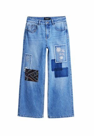Light blue wide-leg jeans featuring multiple fabric patches in various patterns and textures, including floral and geometric designs.