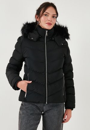 Black puffer jacket with a zip front, chevron pattern, and removable fur-lined hood. Features side pockets and a fitted design.