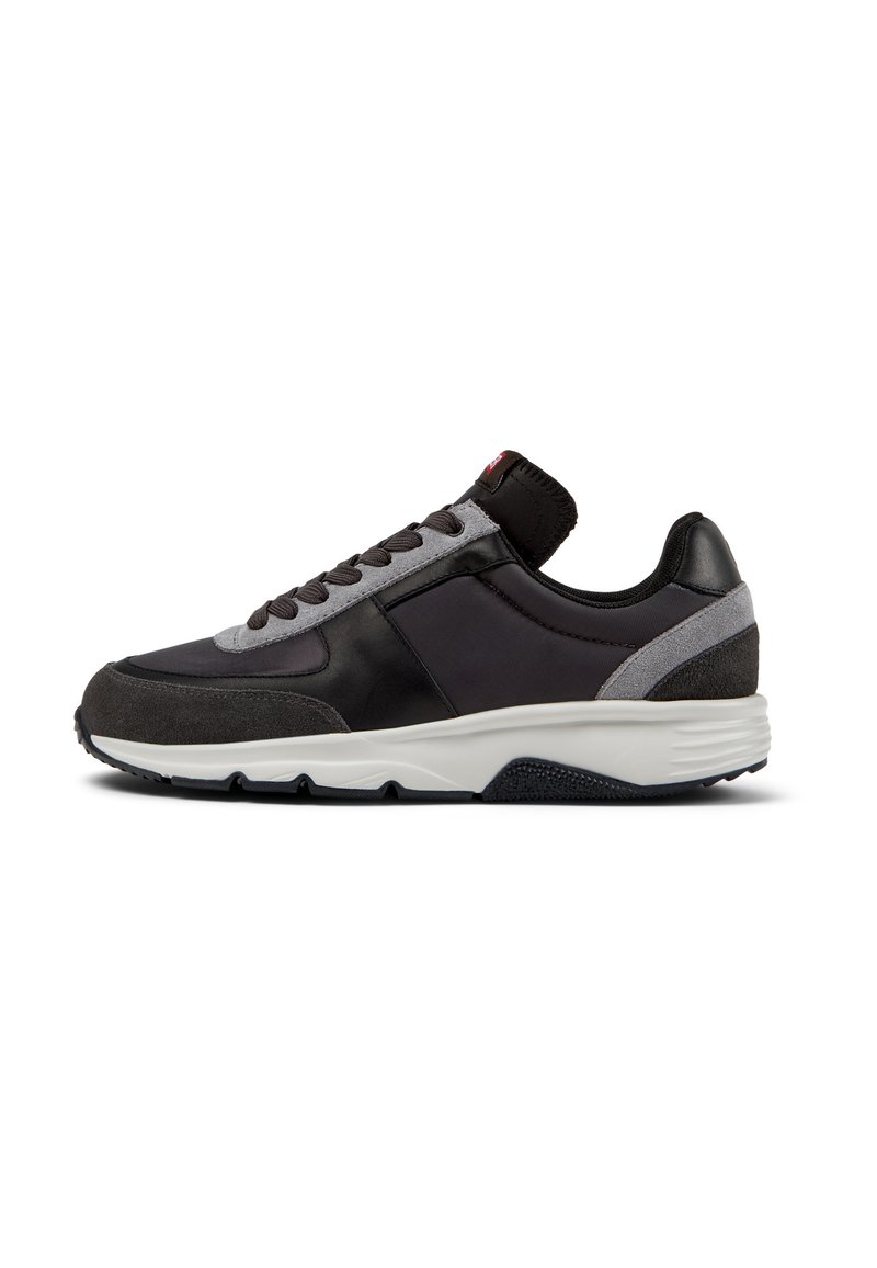 Black and gray sneaker with a mixed material design, featuring leather and suede accents, a textured sole, and lace-up closure.