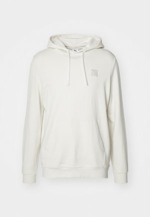 Light beige hoodie made from cotton blend material. Features a kangaroo pocket, drawstring hood, and small logo patch on the chest.