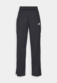 Svarta träningbyxor med elastisk midja, sidostripedetaljer och en liten vit logotyp på övre högra låret. Slät textur, taperad design.