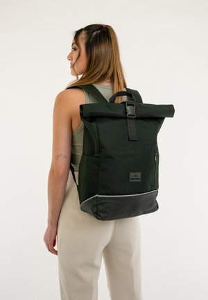 Green roll-top backpack made of fabric with a smooth texture, featuring a front zipper pocket, adjustable straps, and reflective accent.
