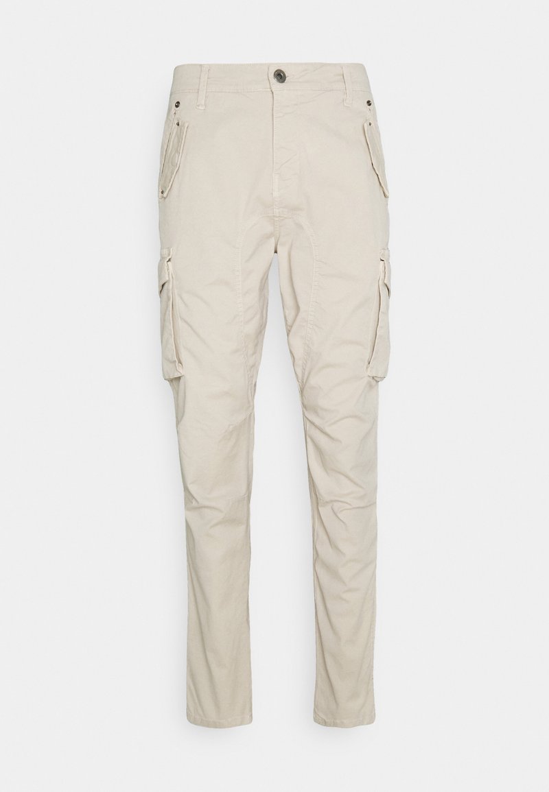 Beige cargo kalhoty s uvolněným střihem, které mají několik bočních kapes, zapínání na knoflík a měkký, strukturovaný bavlněný materiál.