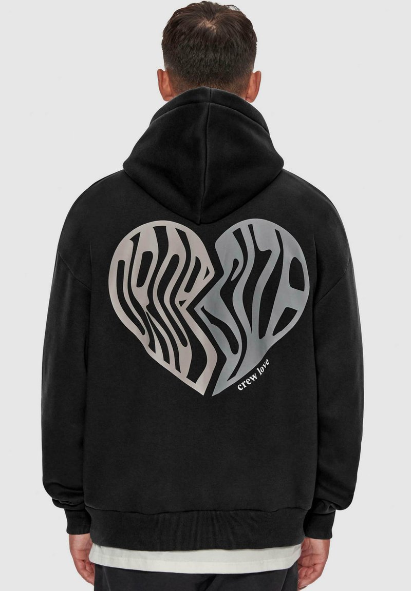Black hoodie featuring a large heart graphic on the back with an abstract zebra pattern in silver. Includes "crew love" text along the bottom.