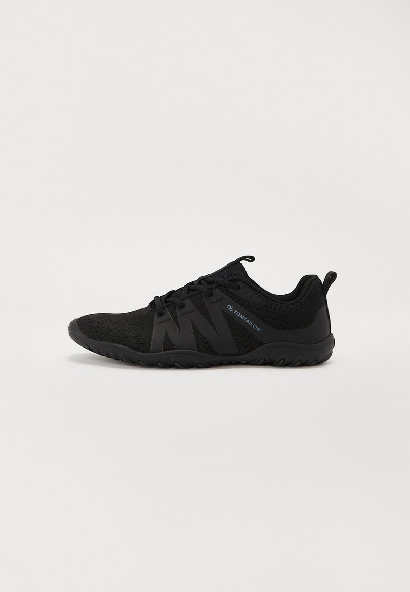 Black athletic shoes with a knitted upper, featuring a sleek design, textured surface, and a rubber sole. Logo detail on the side.