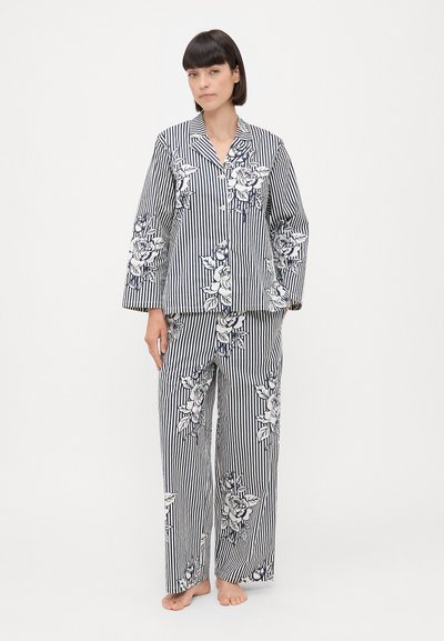 Striped pajama set in navy and white, featuring floral patterns. The top has a notched collar and the bottoms are wide-leg. Cotton blend material.